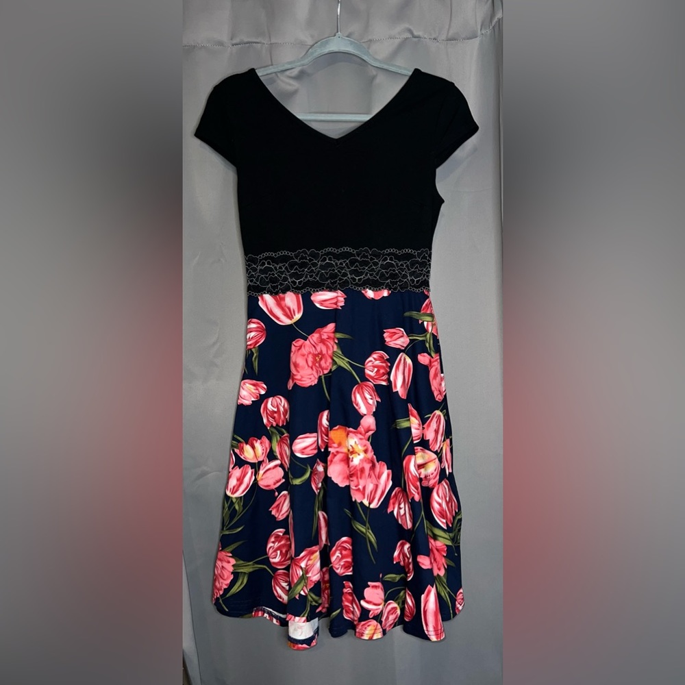 Never worn. Black Top, colorful floral bottom. Floral embroidered stomach line.